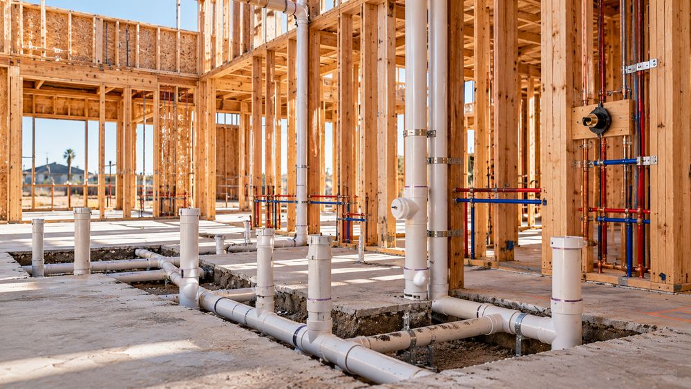 New wood-frame construction with underground drain lines, vents, and supply rough-in